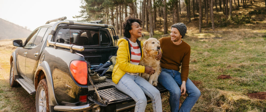 couple and dog on truck bed